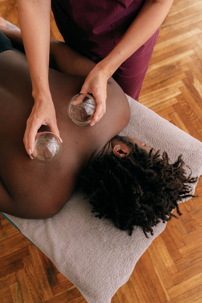 Overhead view of a man receiving cupping therapy, promoting relaxation and wellness.